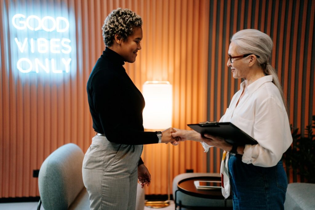 two woman handshaking