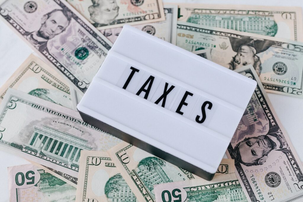 taxes box over dollar bills